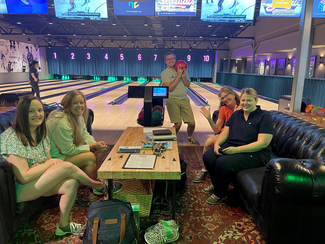 Group of five medical students having fun at a bowling alley.